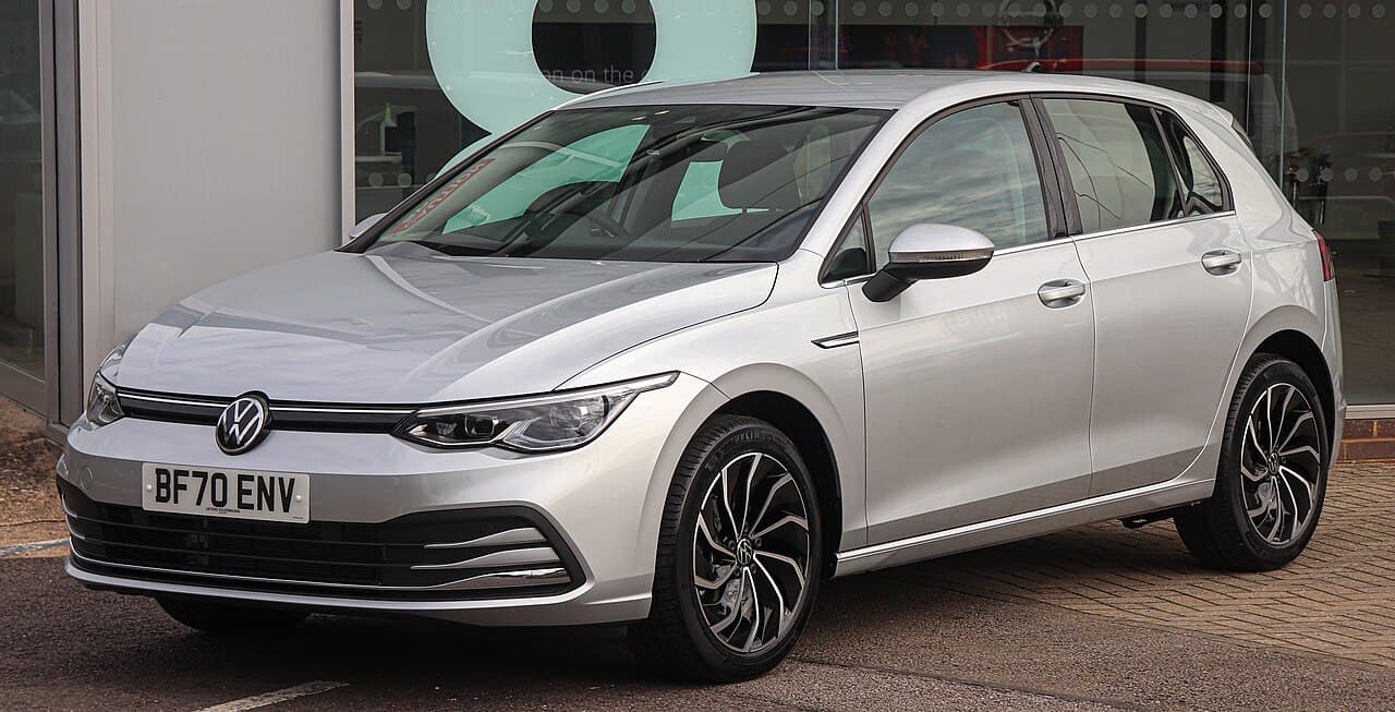 Volkswagen Golf grise devant un bâtiment