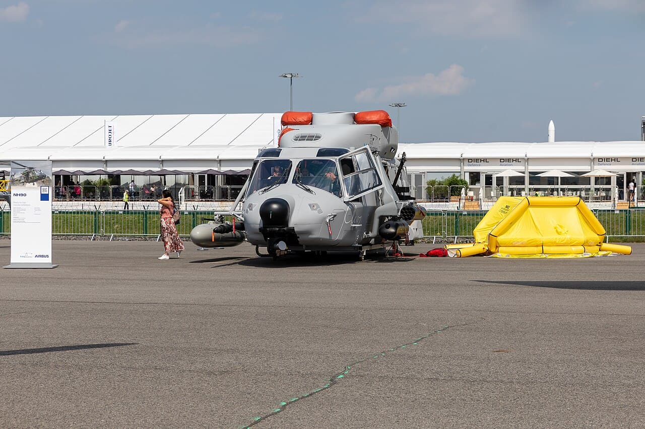 Hélicoptère militaire stationné sur un tarmac